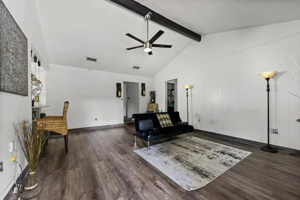 a living room with couch and wooden floor