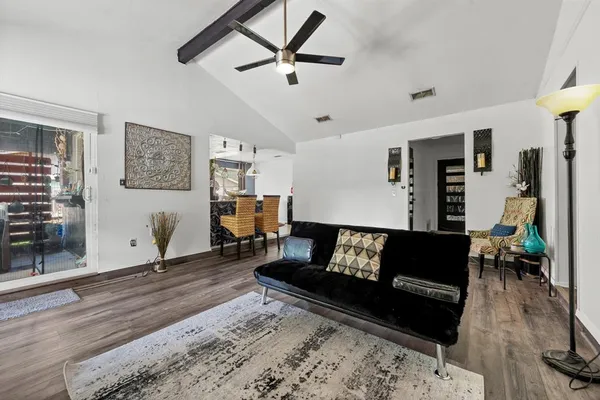 a living room with furniture and wooden floor