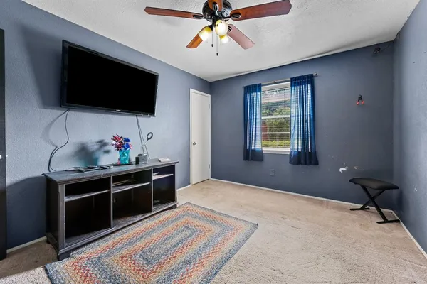 a bed room with a bed and a flat screen tv