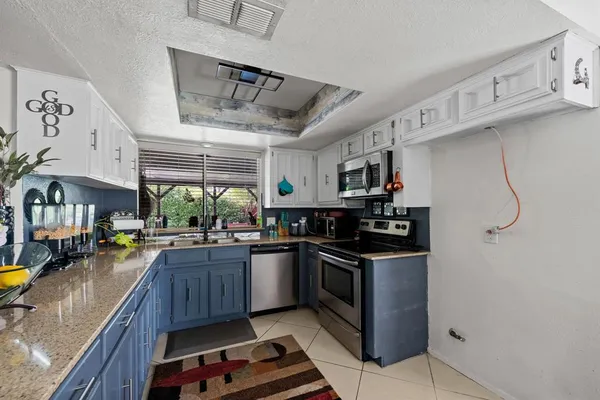 a kitchen with stainless steel appliances granite countertop a stove and a sink