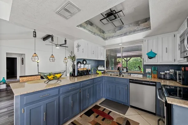 a kitchen with a sink appliances and cabinets