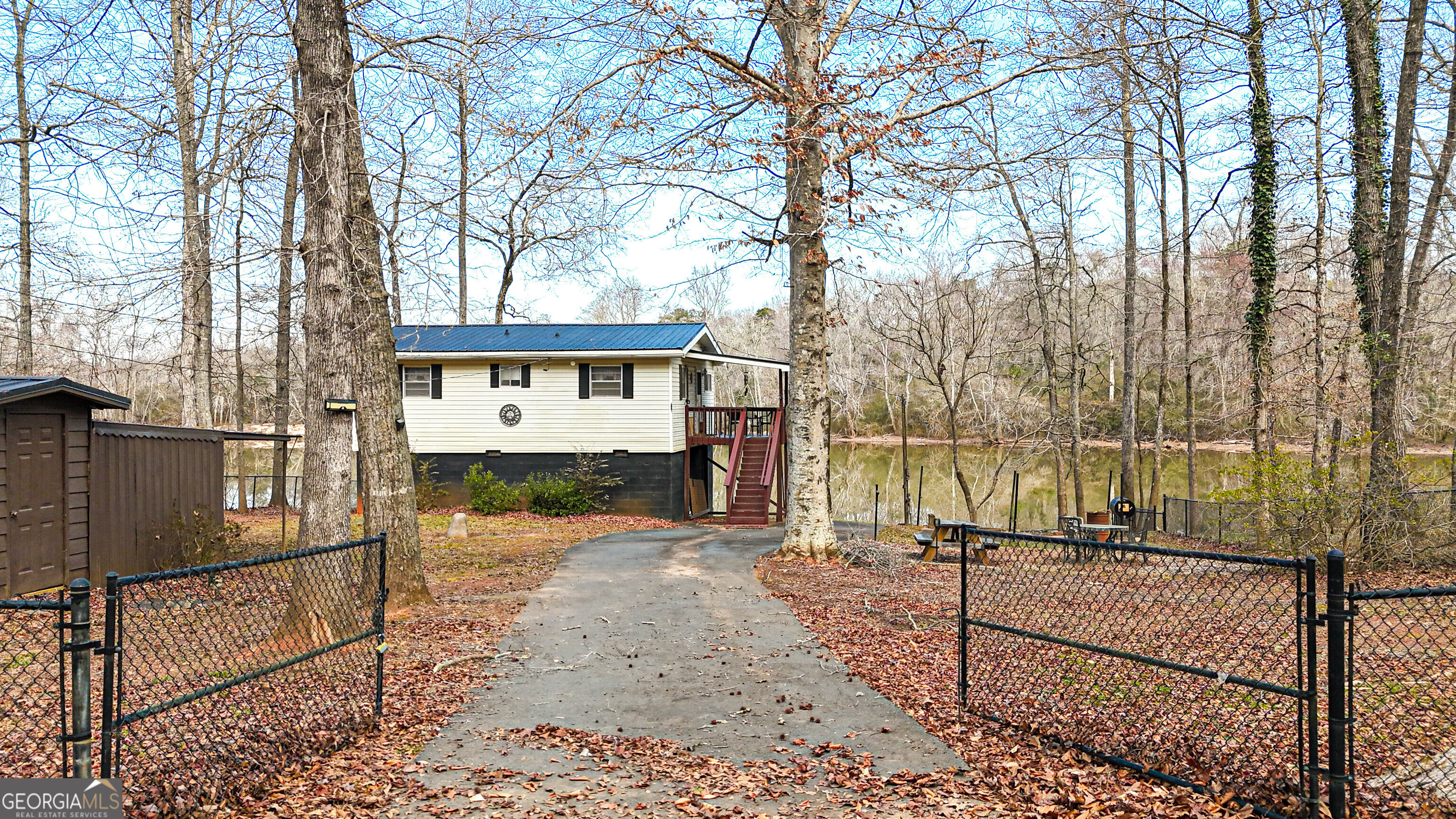 242 Katy Lake Road Jackson, GA 30233 - Photo 103 of 113 a view of a house with a wooden fence