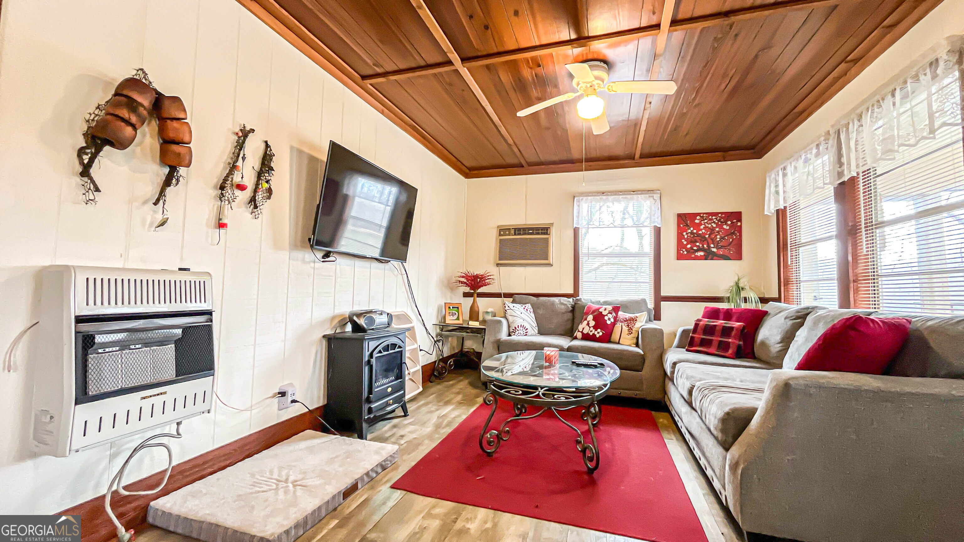 242 Katy Lake Road Jackson, GA 30233 - Photo 13 of 113 a living room with furniture a flat screen tv and a floor to ceiling window
