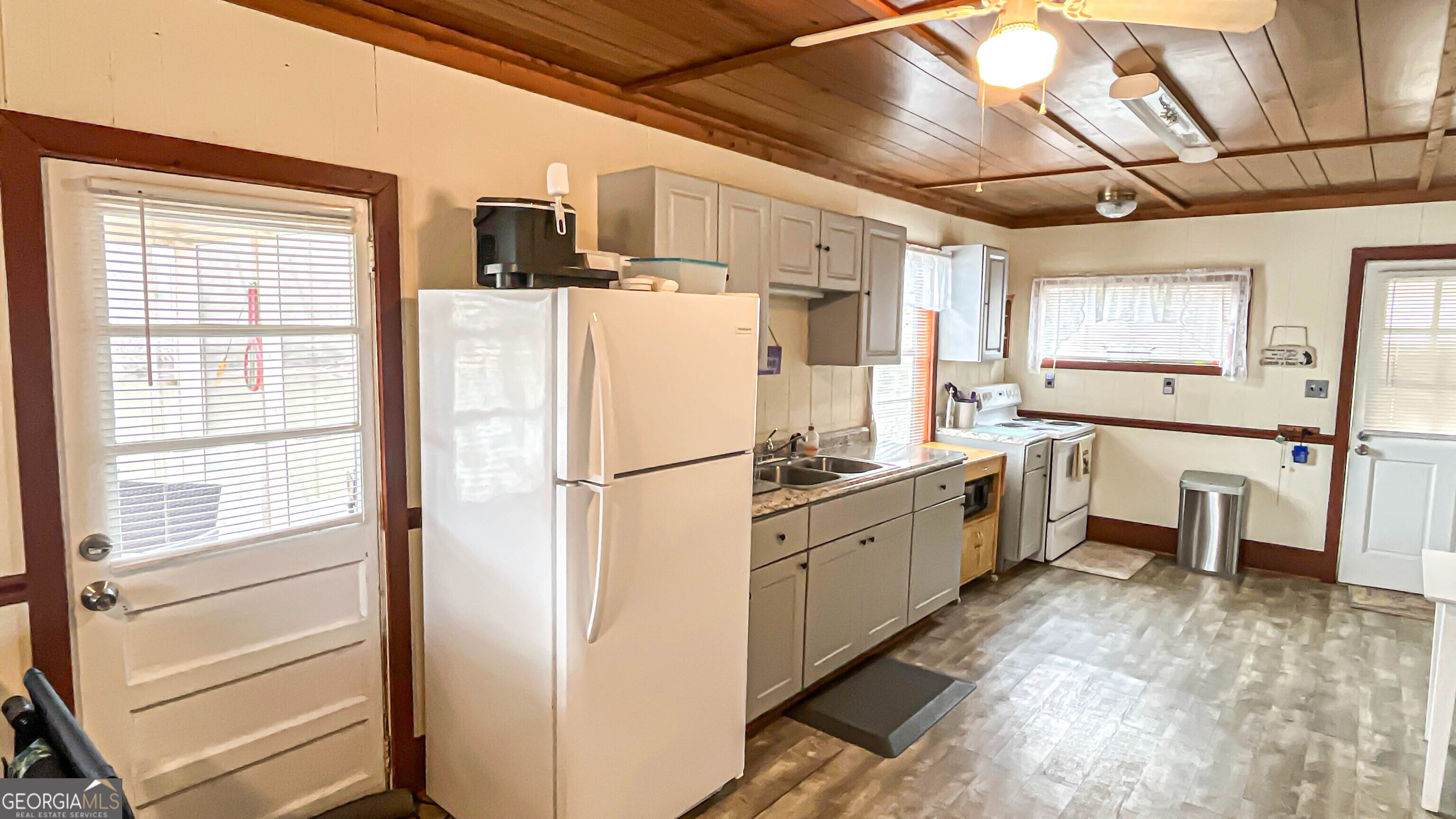 242 Katy Lake Road Jackson, GA 30233 - Photo 18 of 113 a kitchen with white cabinets and white appliances