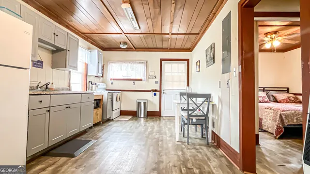 a bedroom with furniture and a flat screen tv