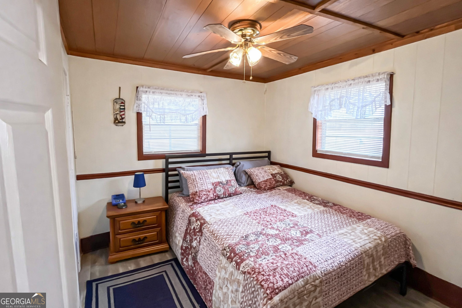 242 Katy Lake Road Jackson, GA 30233 - Photo 30 of 113 a bedroom with a bed and a chandelier