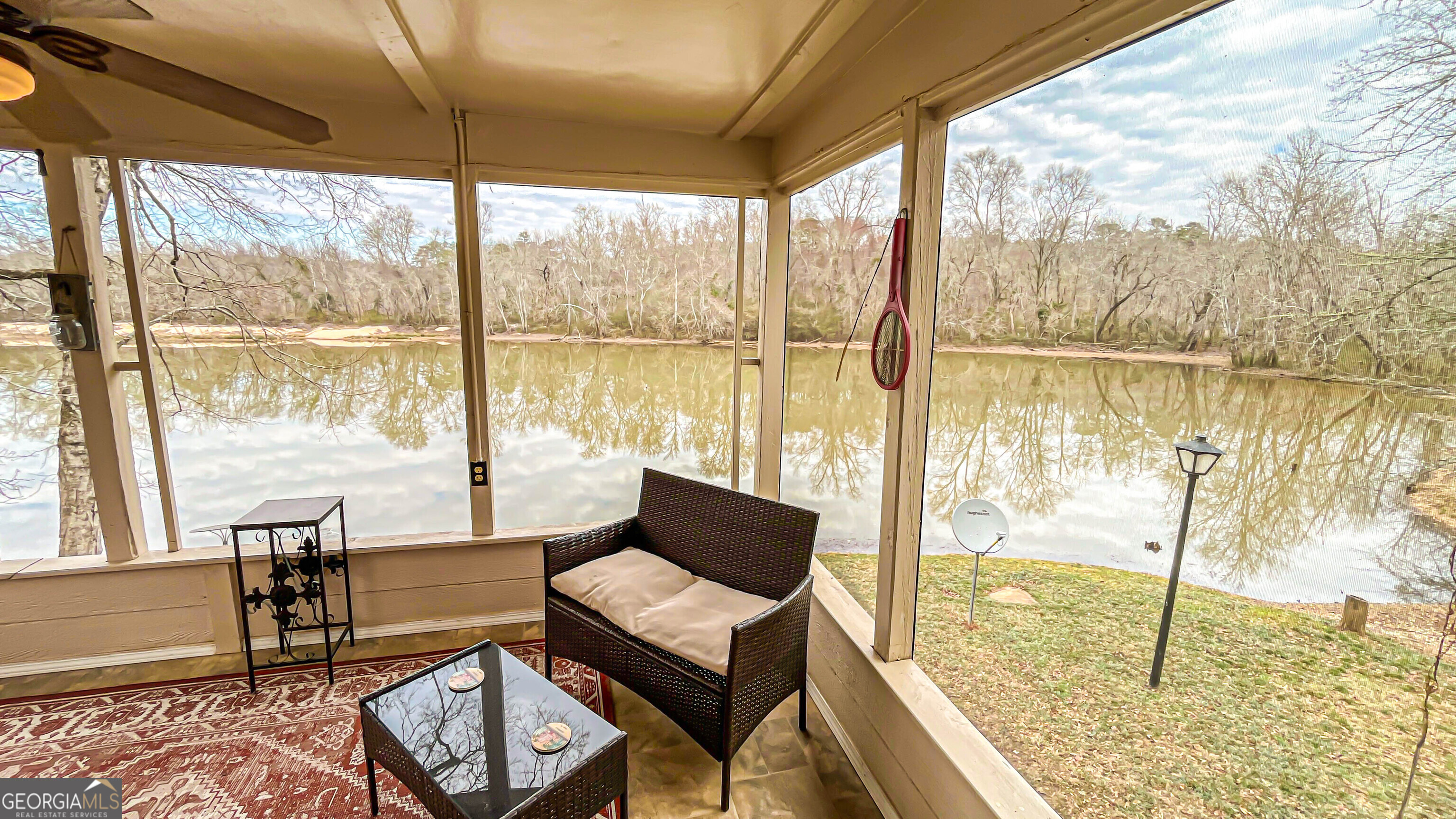 242 Katy Lake Road Jackson, GA 30233 - Photo 44 of 113 a living room with a floor to ceiling window next to a yard