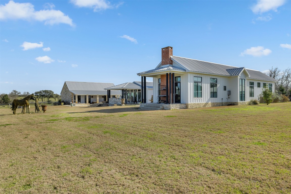 4620 Treybig Loop Fayetteville, TX 78940 - Photo 22 of 24 a front view of a building with a garden