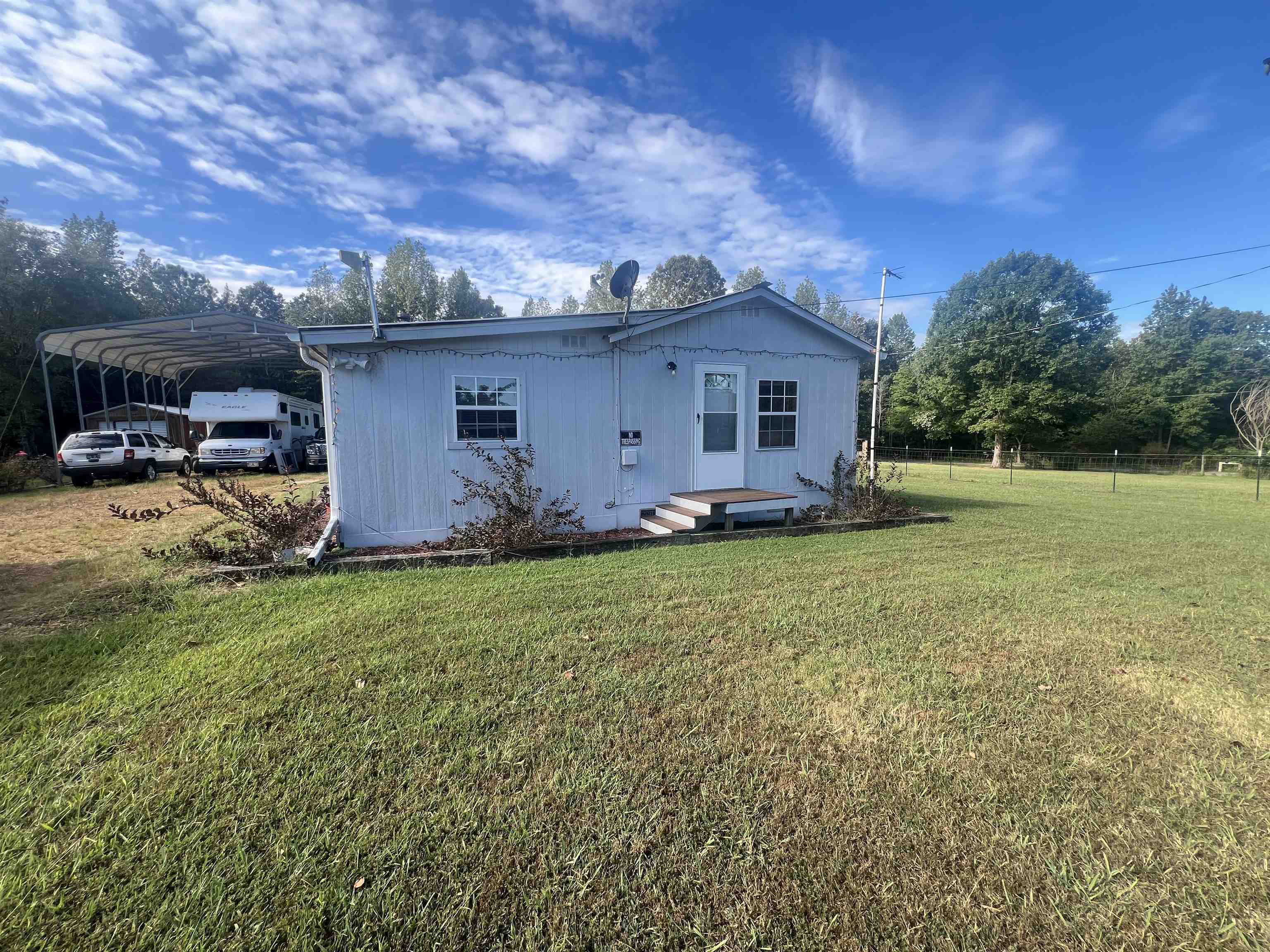 160 Finley Road Adamsville, TN 38310 - Photo 1 of 31 a view of a house with backyard and sitting area