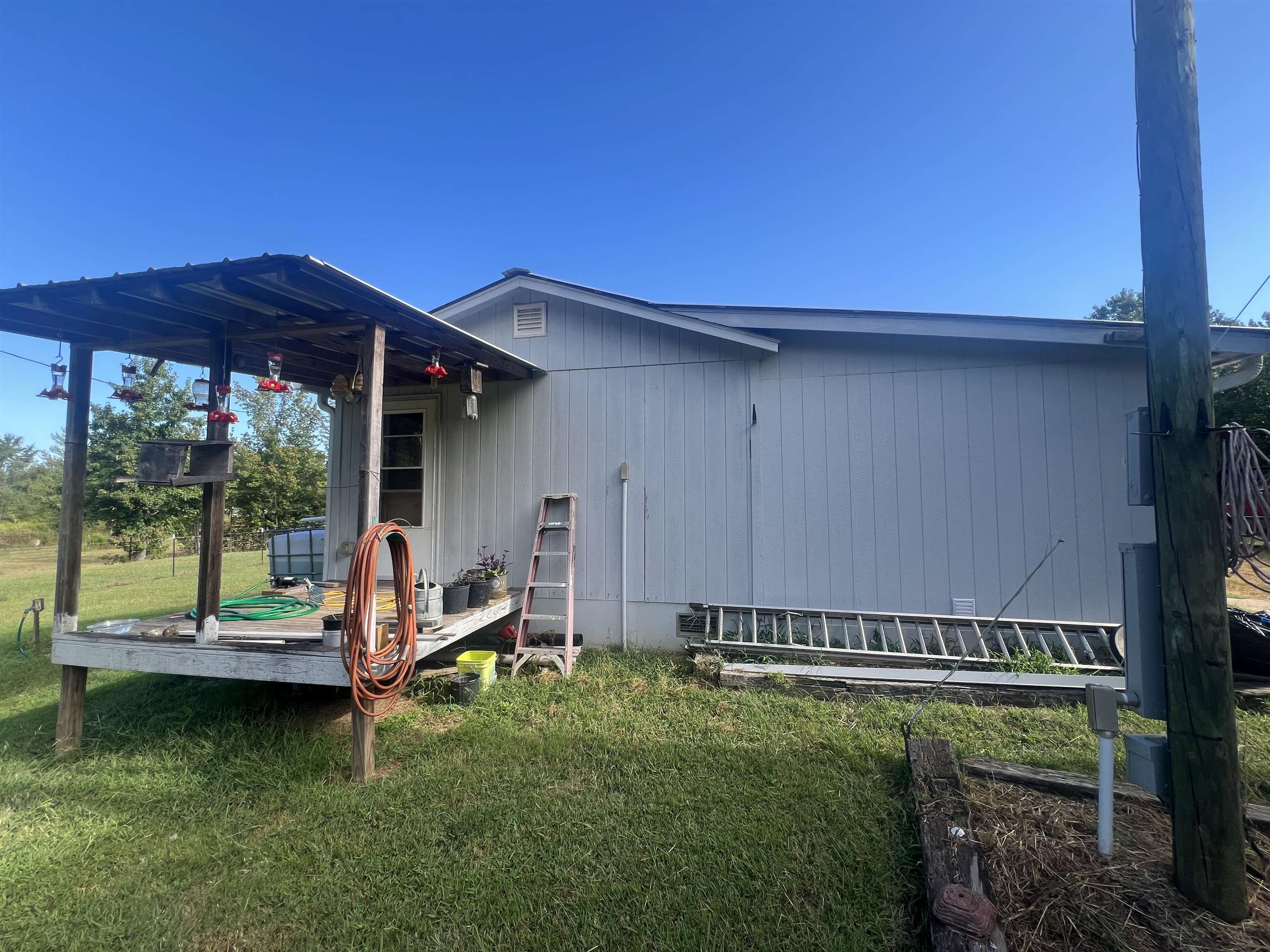 160 Finley Road Adamsville, TN 38310 - Photo 22 of 31 a view of a house with backyard sitting area and garden
