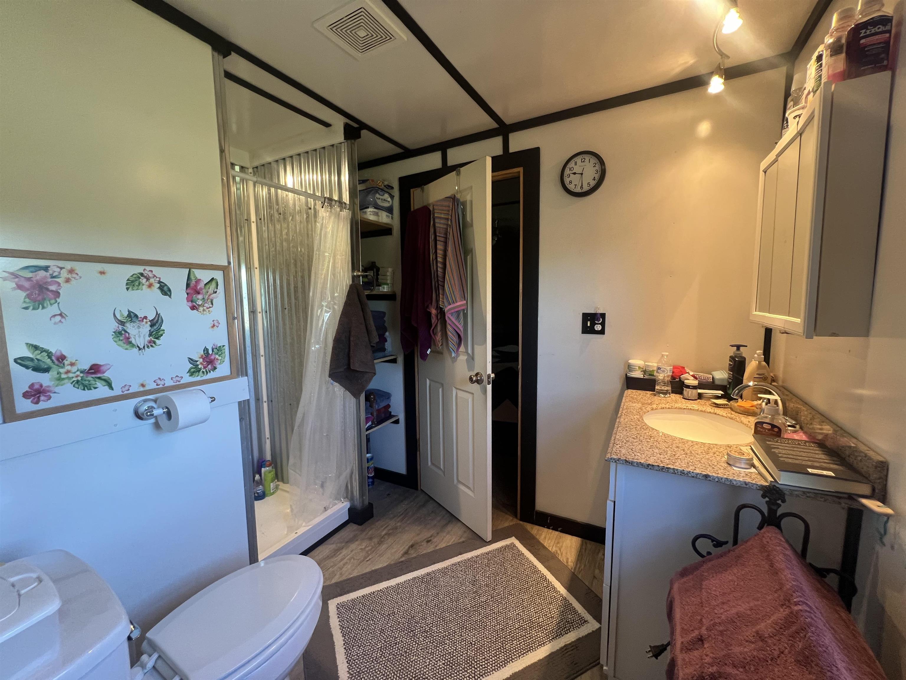 160 Finley Road Adamsville, TN 38310 - Photo 9 of 31 a bathroom with a sink a toilet a mirror and shower