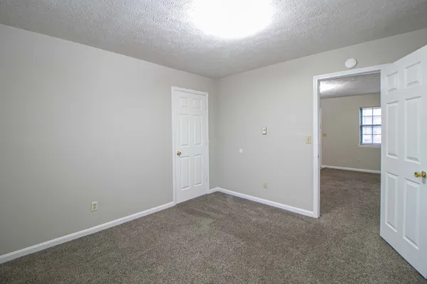 an empty room with windows and entrance