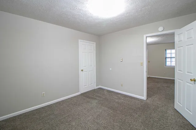 an empty room with windows and entrance