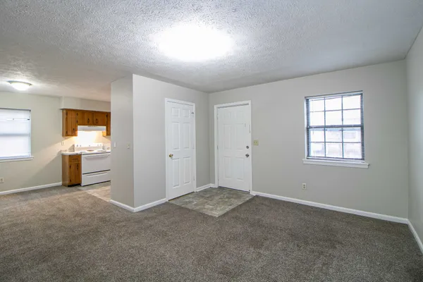 an empty room with windows and closet