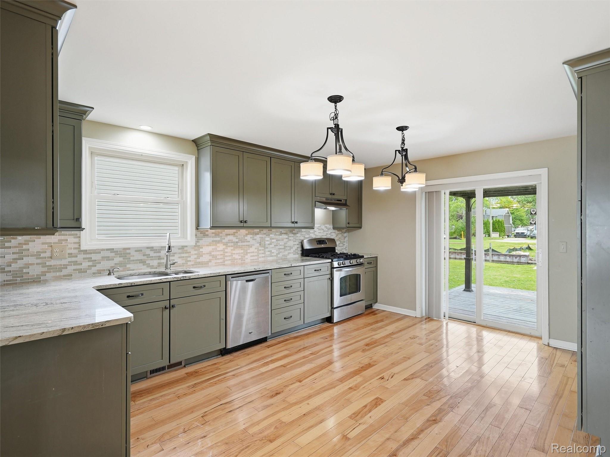 117 Kenyon Road Algonac, MI 48001 - Photo 17 of 47 Kitchen featuring wood-finish flooring, recessed lighting, and olive shaker-style cabinetry
