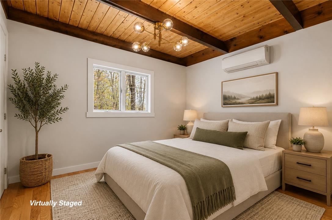 883 Deerfield Road Lake Ariel, PA 18436 - Photo 32 of 81 A tranquil bedroom retreat features exposed wood beam ceilings.