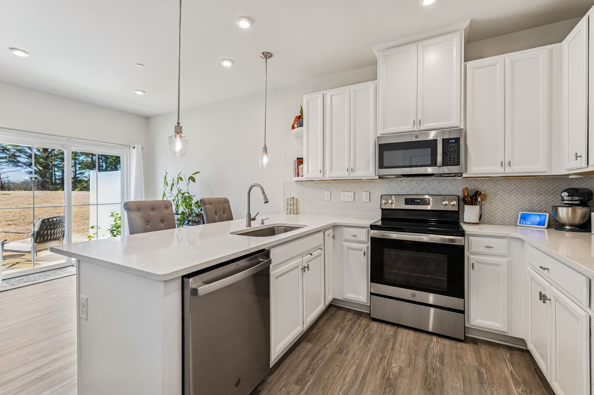 156 Keelon Gap Road Spring Hill, TN 37174 - Photo 14 of 39 a kitchen with stainless steel appliances granite countertop a sink a stove a microwave and cabinets