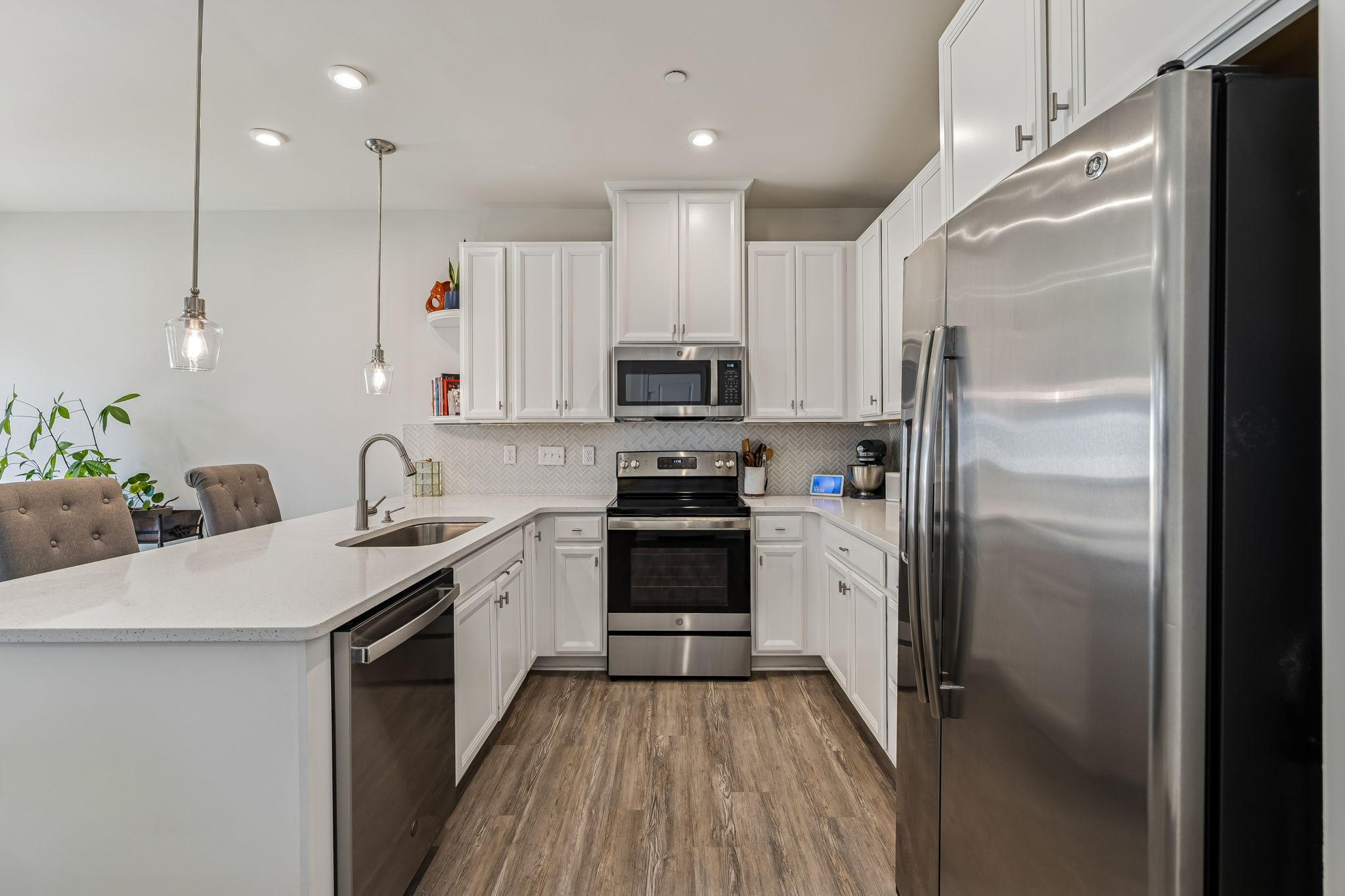 156 Keelon Gap Road Spring Hill, TN 37174 - Photo 16 of 39 a kitchen with granite countertop a refrigerator stove and oven