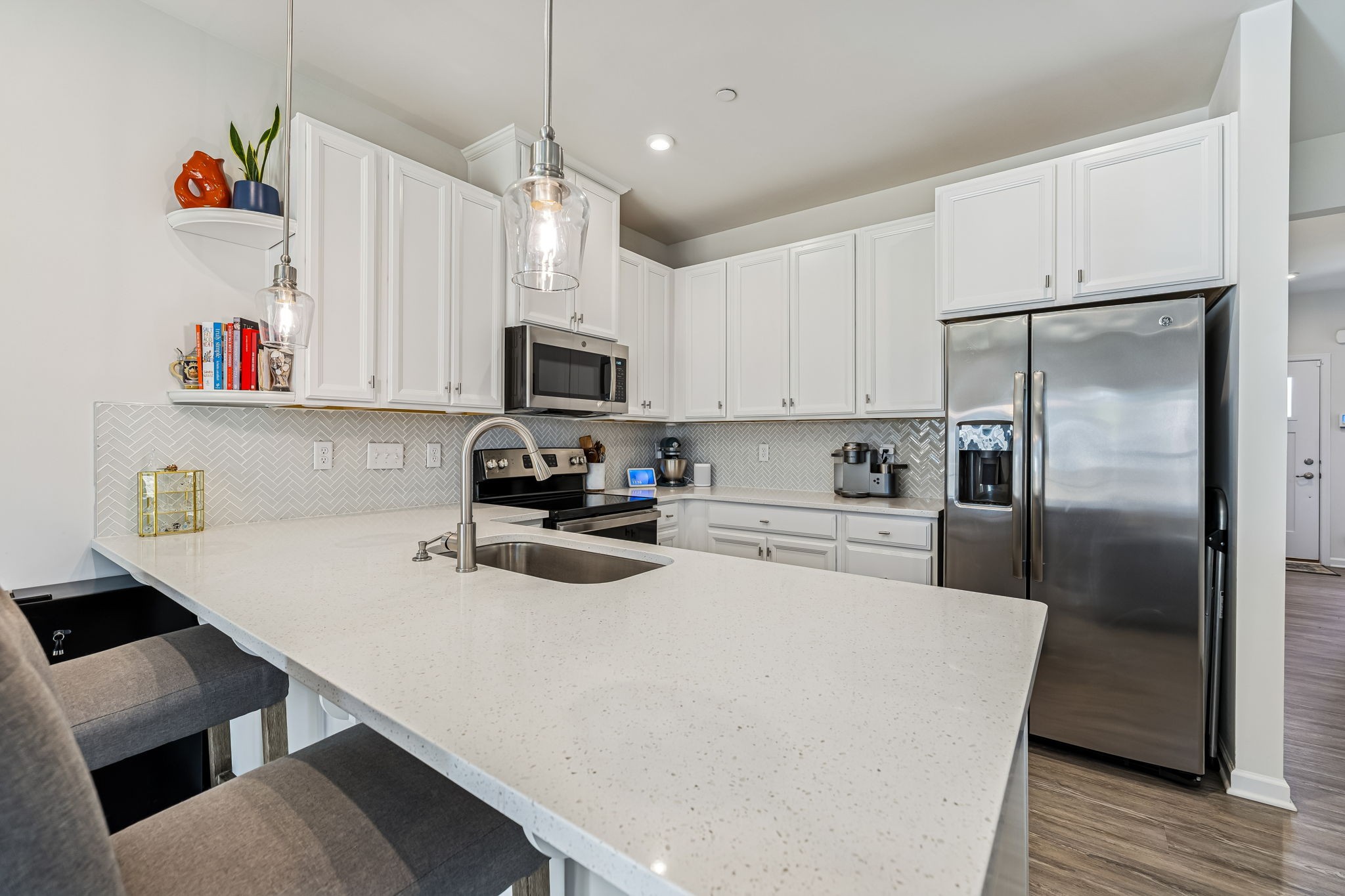 156 Keelon Gap Road Spring Hill, TN 37174 - Photo 21 of 39 a kitchen with kitchen island a stove a sink and a refrigerator