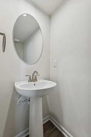 a bathroom with a sink a mirror and vanity