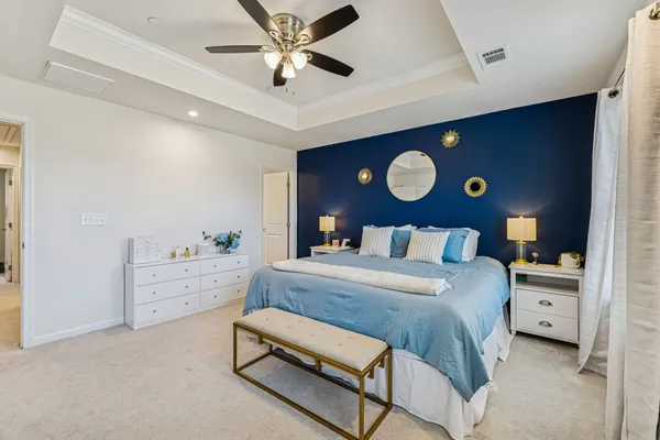 a bedroom with a bed and a chandelier