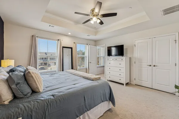 a bedroom with a large bed and a tv