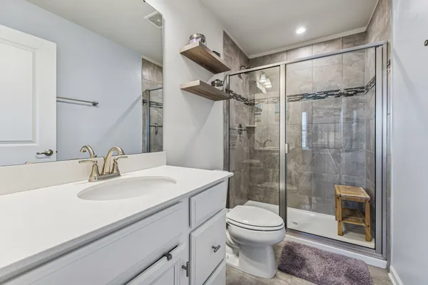 a bathroom with a sink toilet and shower