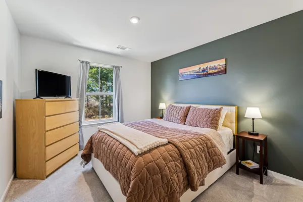 a bedroom with a bed and a flat screen tv