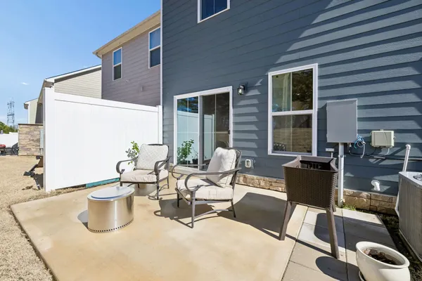 a view of a patio with dining table and chairs and potted plants