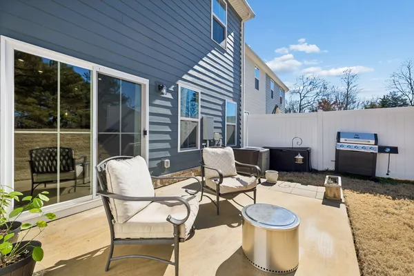 a view of a patio with a dining table and chairs with wooden floor