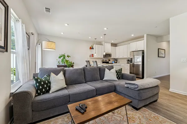 a living room with furniture kitchen and a window