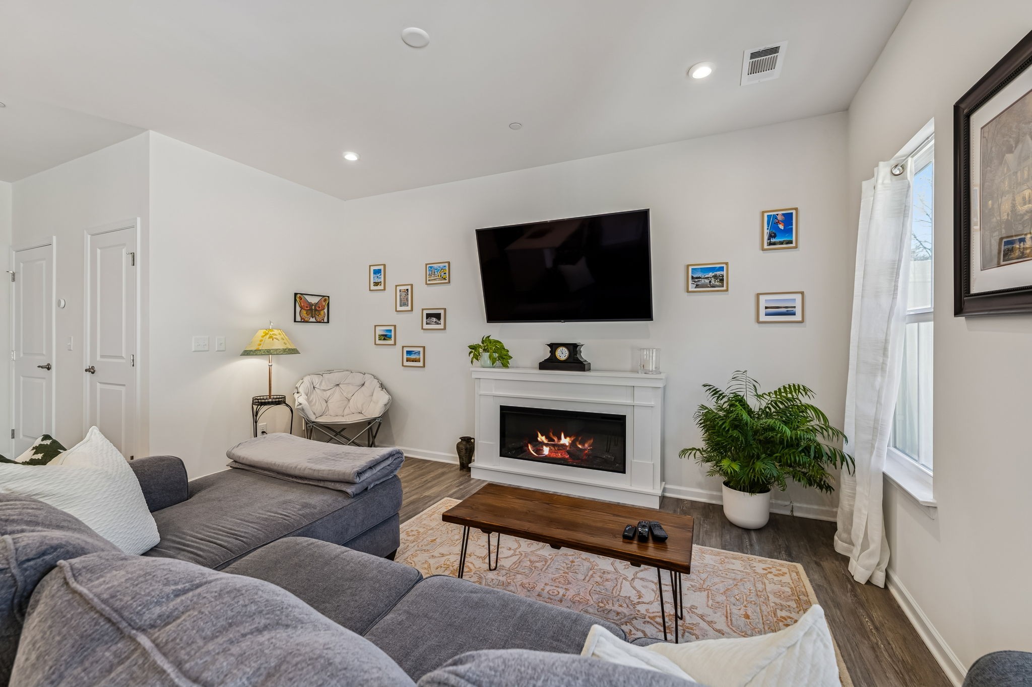 156 Keelon Gap Road Spring Hill, TN 37174 - Photo 10 of 39 a living room with furniture a flat screen tv and a fireplace