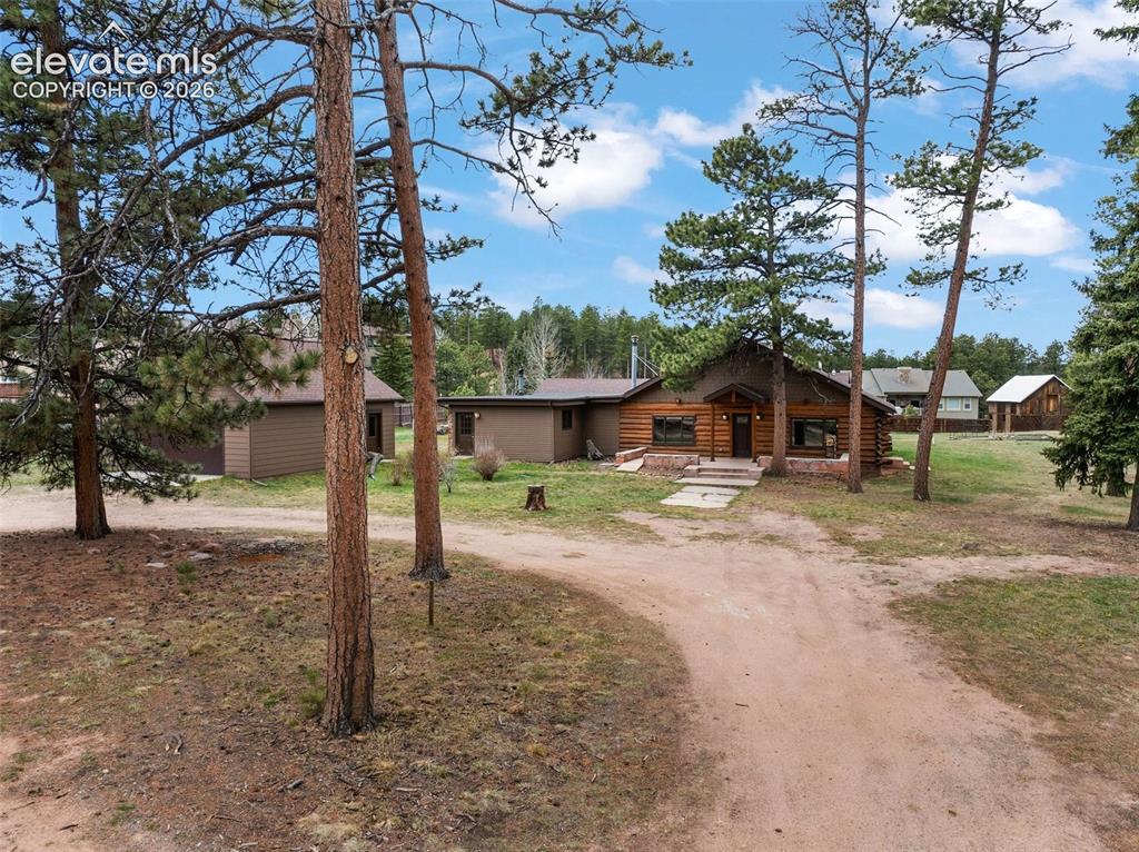 Welcome to this historic mountain retreat, set on 3.74 acres in Woodland Park