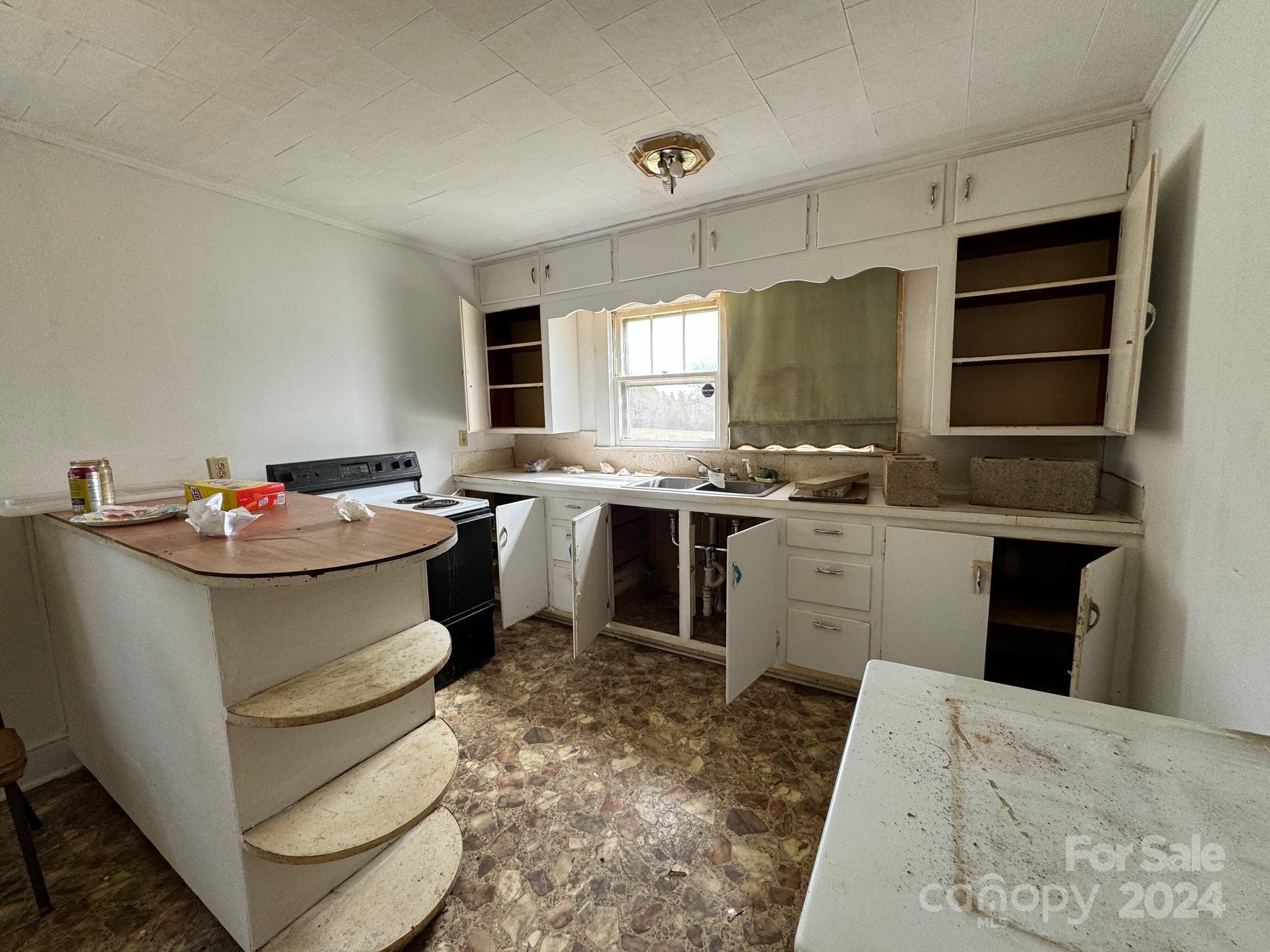 174 Lavender Road Ellenboro, NC 28040 - Photo 11 of 20 a kitchen with a sink stove and cabinets