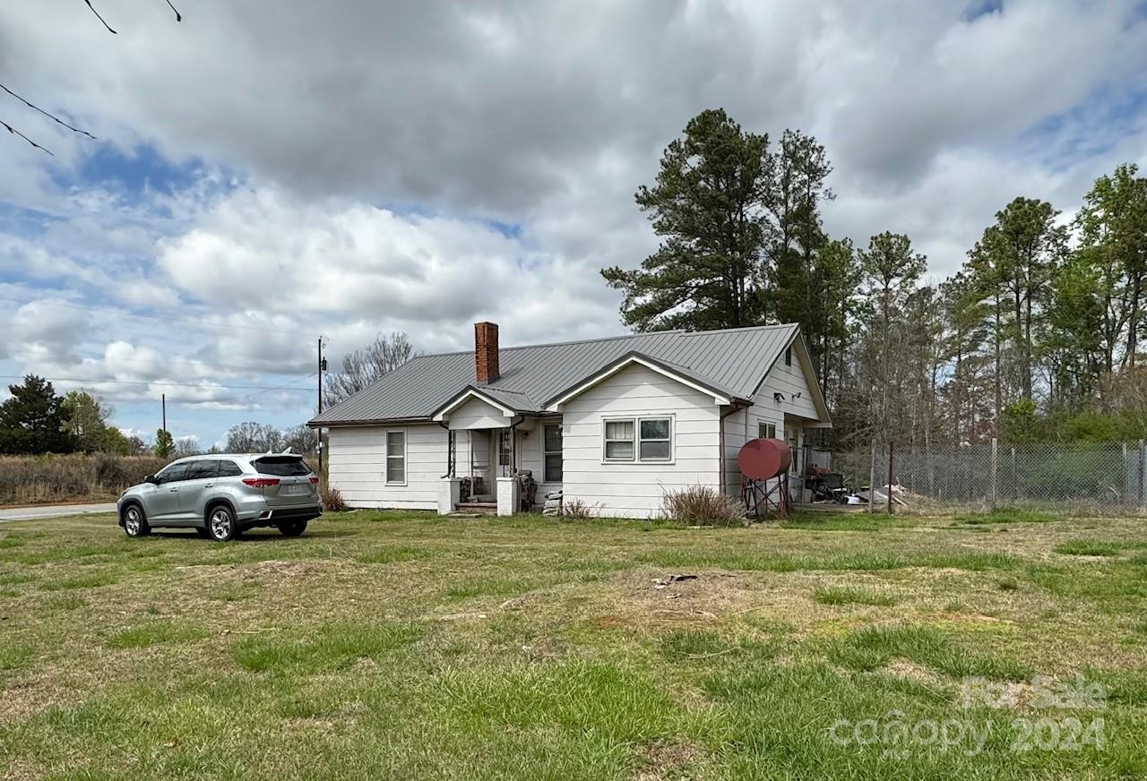 174 Lavender Road Ellenboro, NC 28040 - Photo 2 of 20 a car parked in front of white house