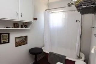 a room with a walk in closet and a wooden floor