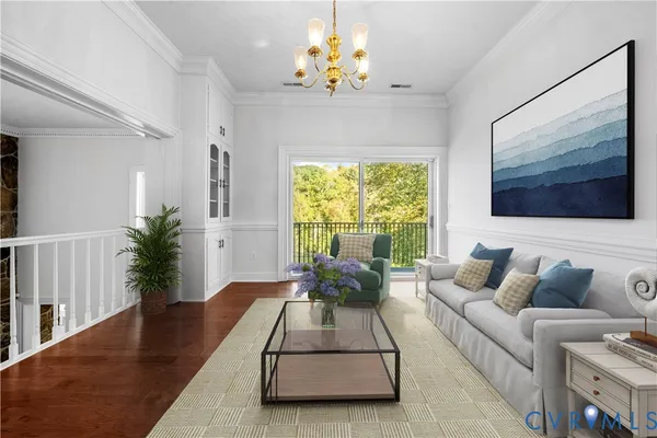 a living room with furniture chandelier and a flat screen tv