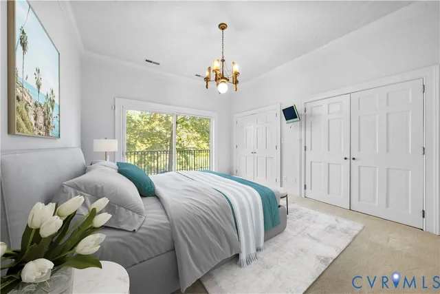 a bedroom with a bed mirror and window