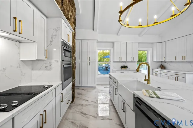 a kitchen with stainless steel appliances granite countertop a sink and cabinets