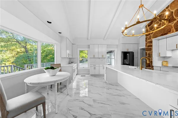 a large white kitchen with a large window