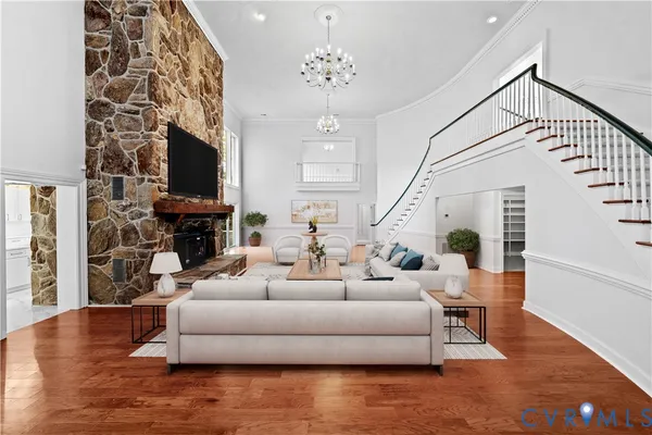 a living room with furniture a fireplace and a flat screen tv