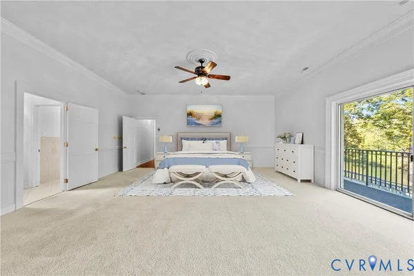 a spacious bedroom with a bed and a chandelier