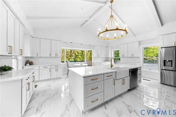a kitchen with white cabinets and window