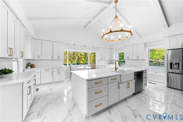 a kitchen with white cabinets and window