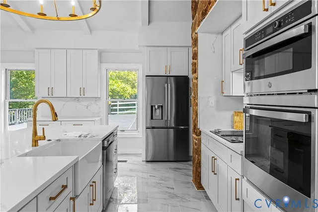 a kitchen with a sink a refrigerator and a stove