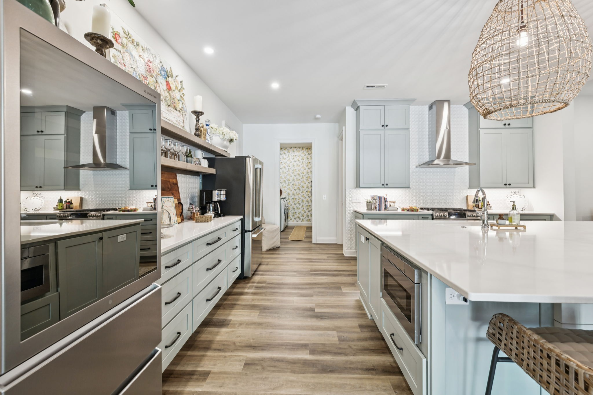 829 Highgrove Circle Franklin, TN 37069 - Photo 51 of 98 a large kitchen with kitchen island a stove a sink dishwasher and white cabinets with wooden floor