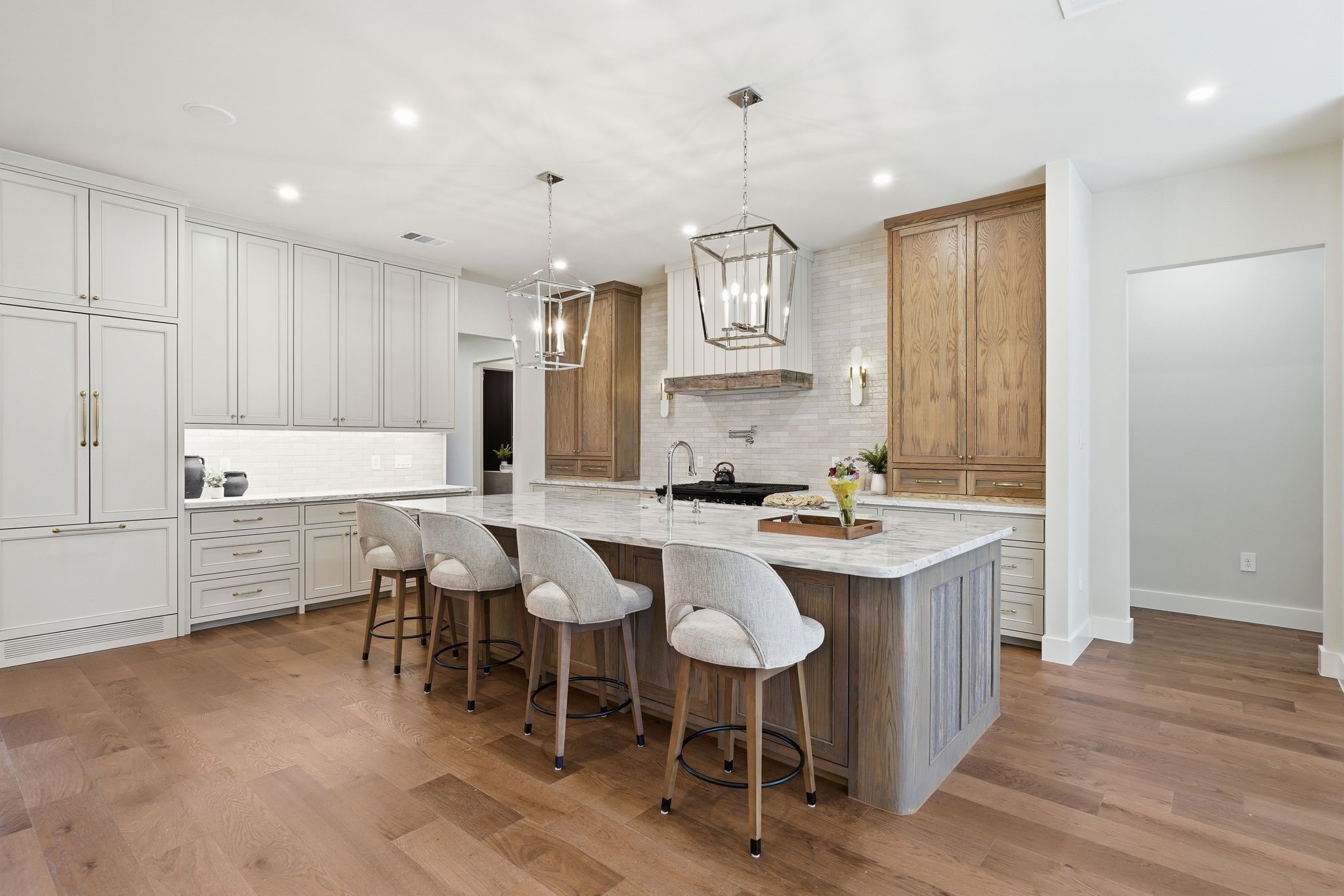 7248 Red Oak Grove Road Montgomery, TX 77316 - Photo 11 of 50 a large kitchen with cabinets a sink dishwasher a dining table and chairs with wooden floor