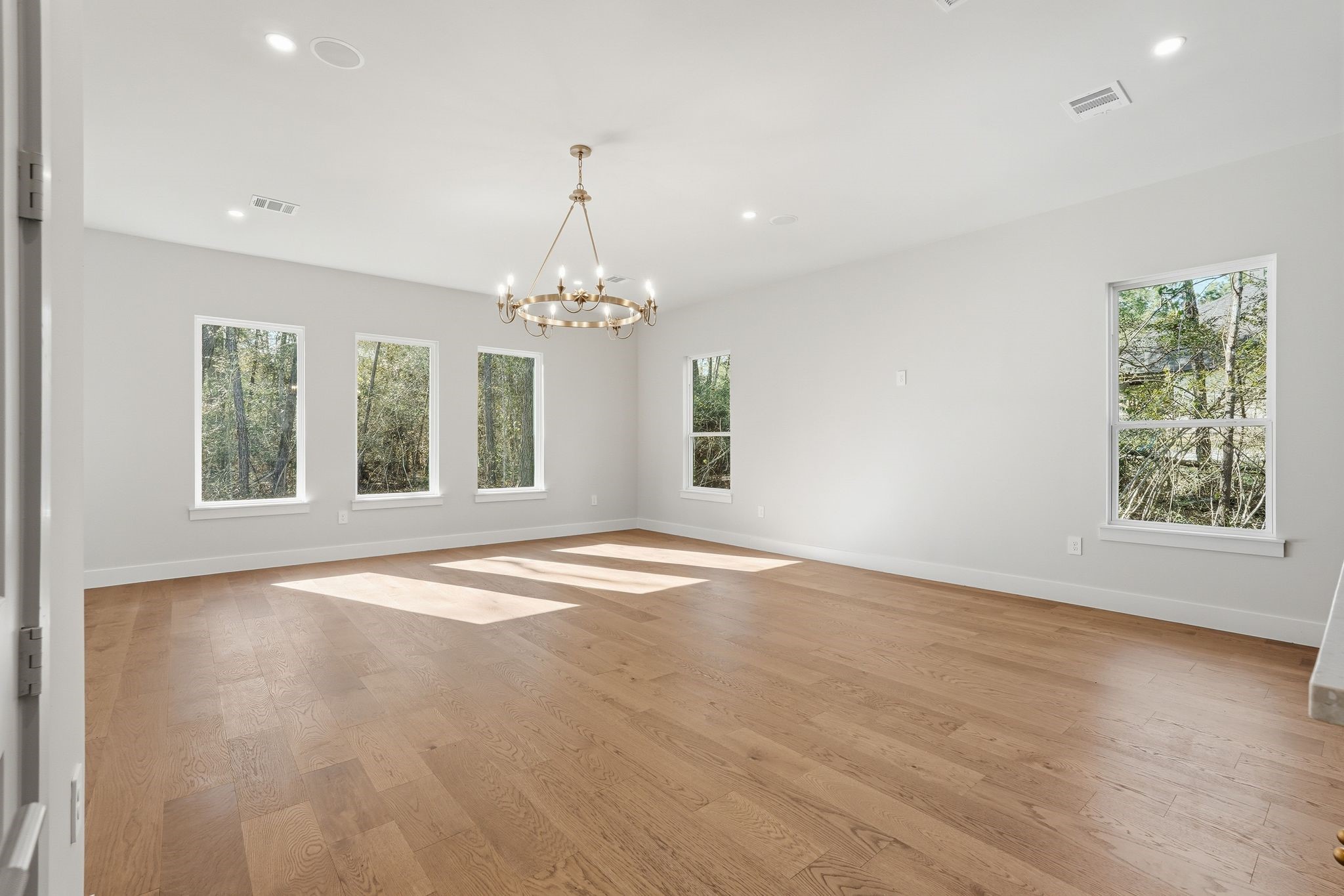 7248 Red Oak Grove Road Montgomery, TX 77316 - Photo 18 of 50 a view of an empty room with wooden floor and a window