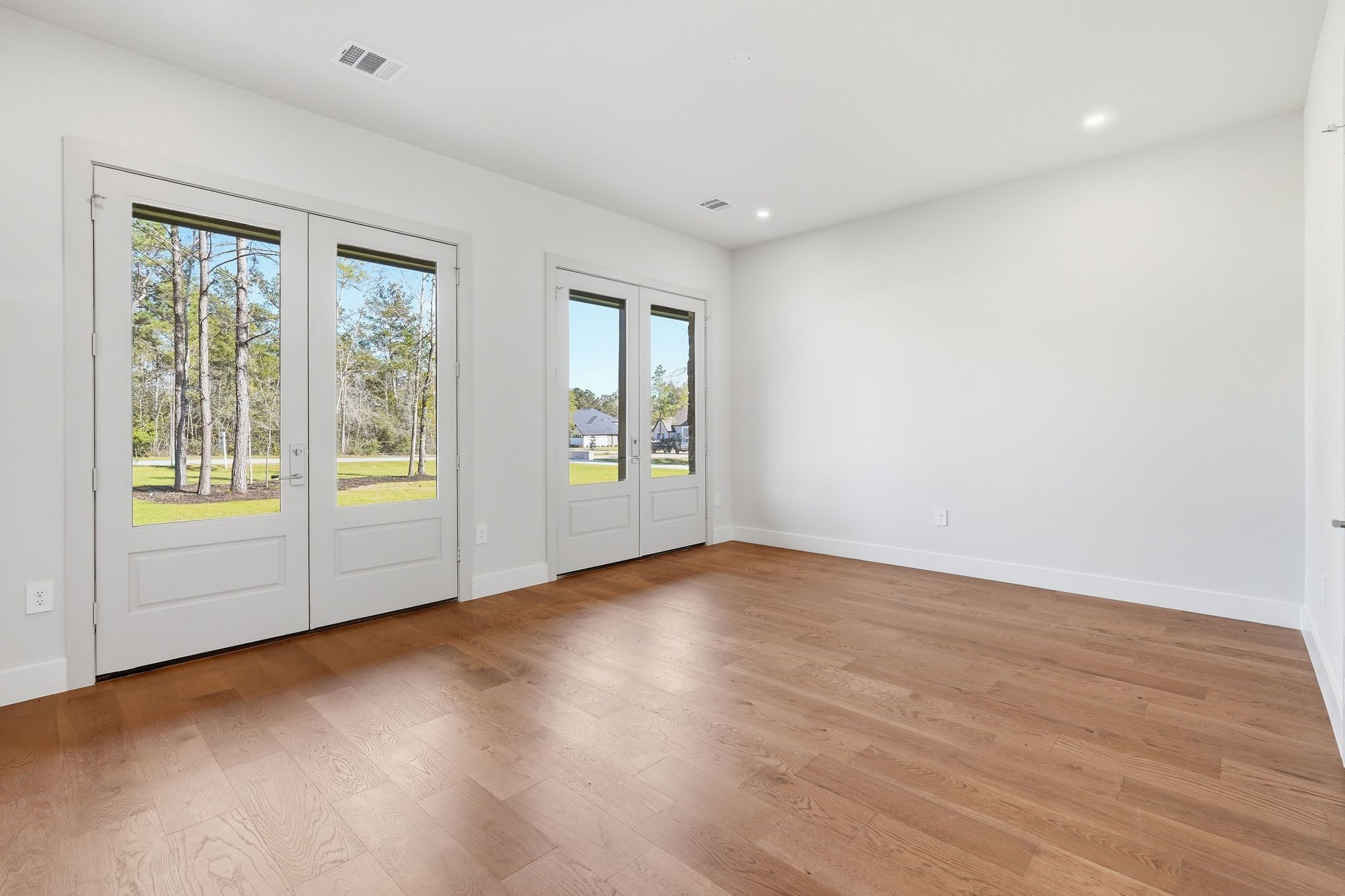 7248 Red Oak Grove Road Montgomery, TX 77316 - Photo 31 of 50 a view of an empty room with wooden floor and a window