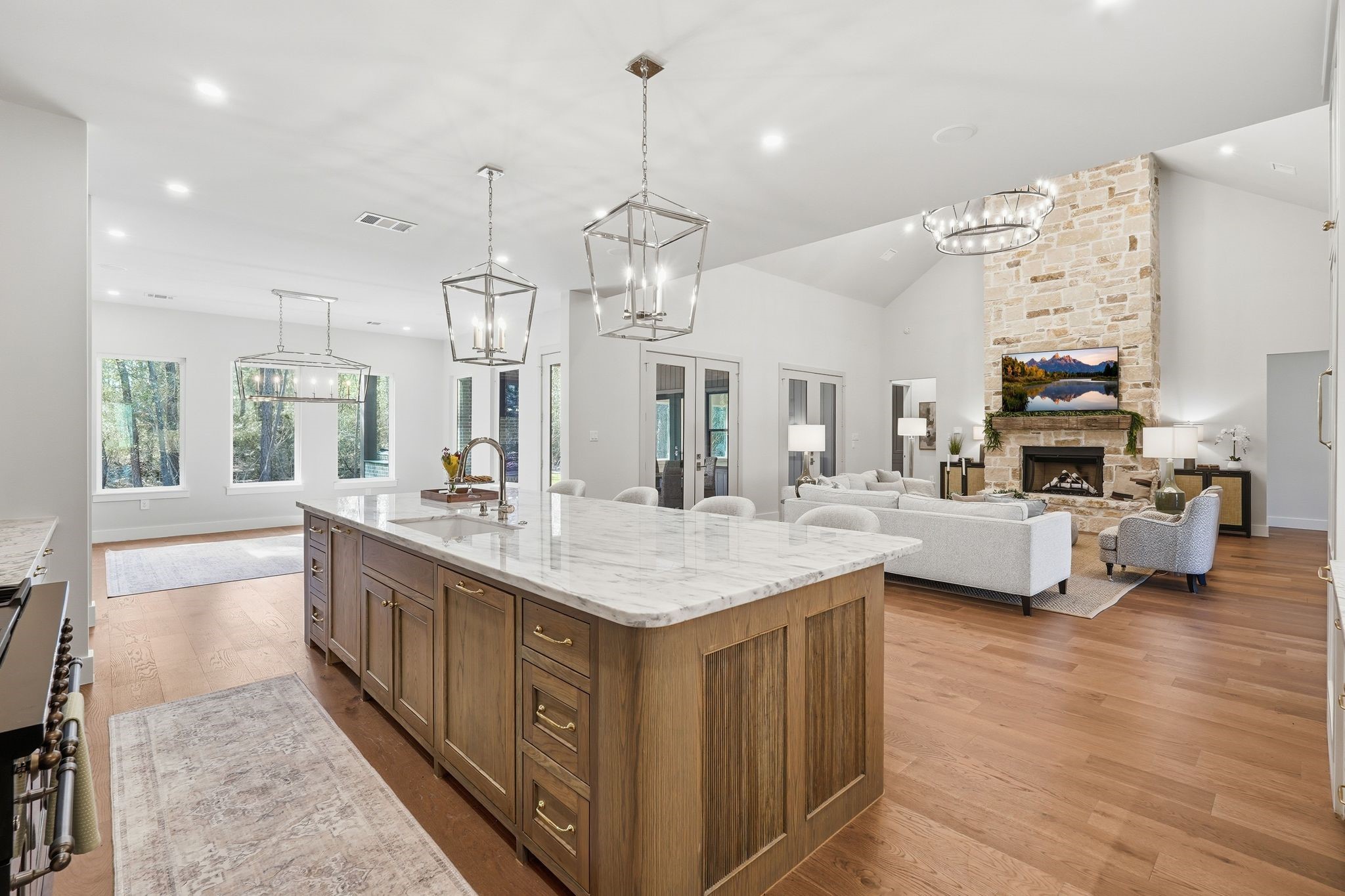 7248 Red Oak Grove Road Montgomery, TX 77316 - Photo 6 of 50 a large kitchen with kitchen island a large counter space a sink appliances and living room view